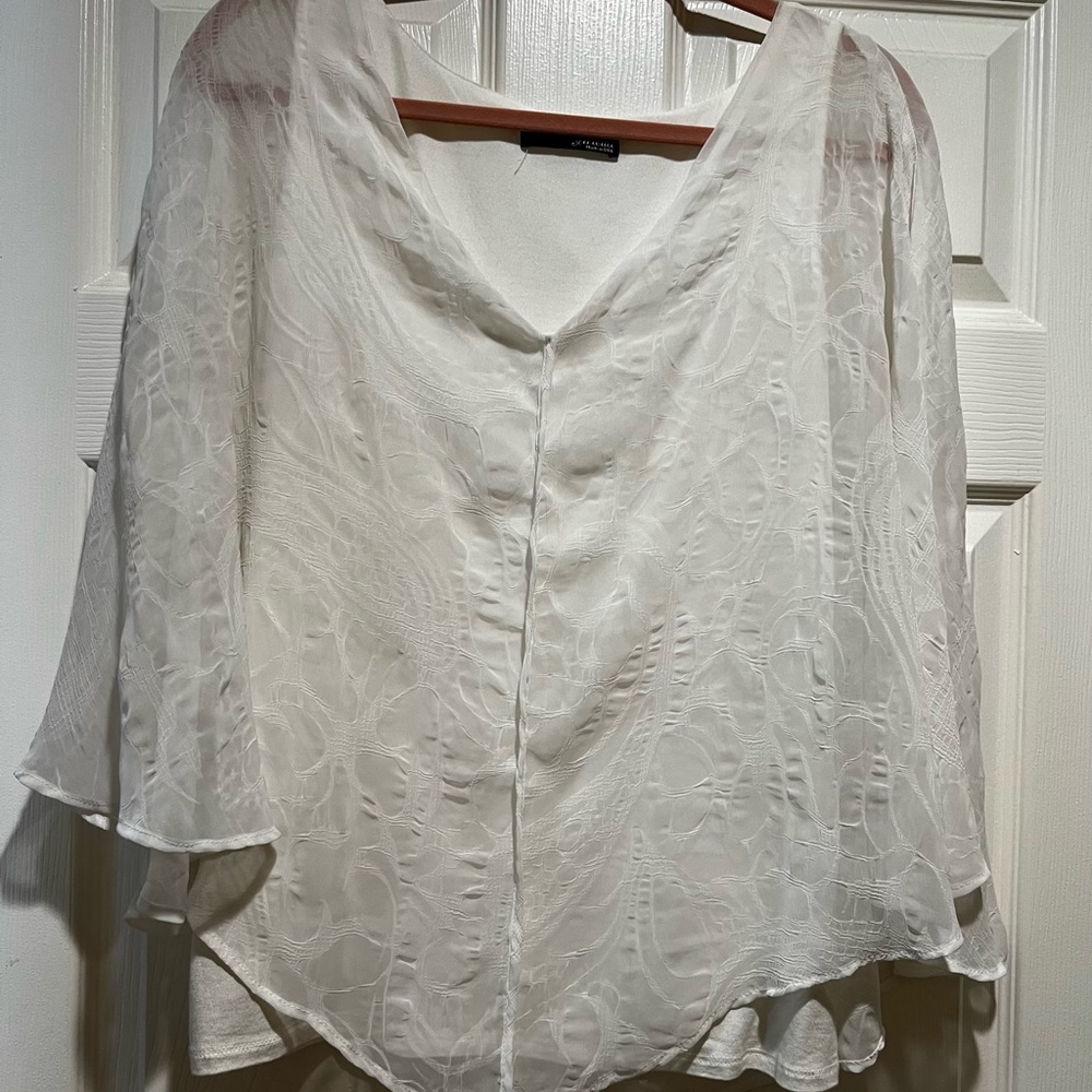 Beautiful white gooey shirt with tank top on the inside. Very comfortable